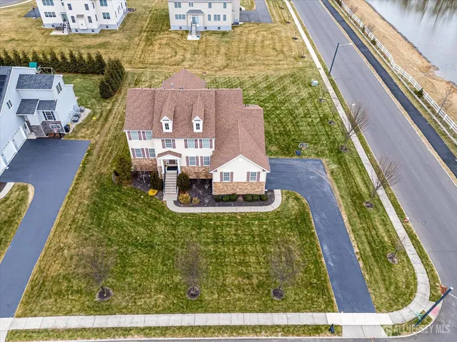 a view of a hallway with wooden floor fireplace and dining room