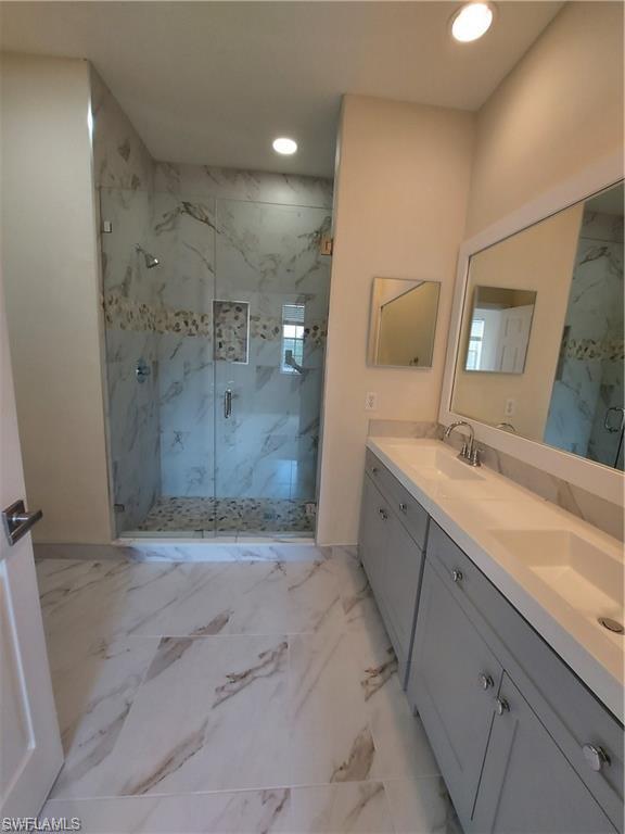 3268 Amanda Lane, Unit 3 Naples, FL 34109 - Photo 11 of 26 a spacious bathroom with a granite countertop sink a shower and a mirror
