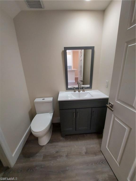 3268 Amanda Lane, Unit 3 Naples, FL 34109 - Photo 16 of 26 a bathroom with a sink toilet and mirror