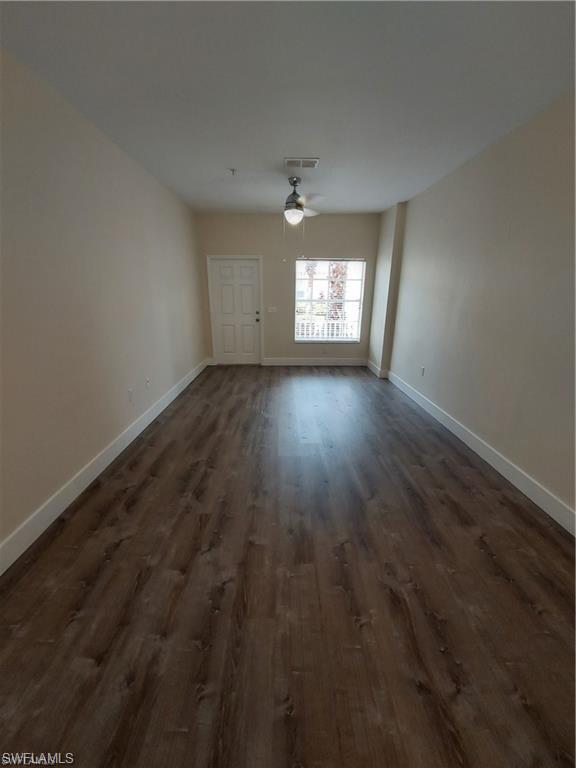 3268 Amanda Lane, Unit 3 Naples, FL 34109 - Photo 21 of 26 an empty room with wooden floor and windows