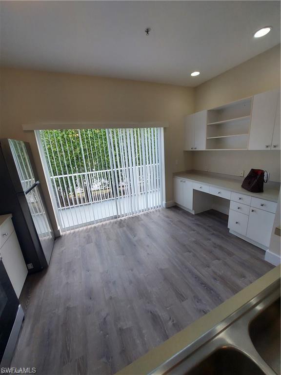 3268 Amanda Lane, Unit 3 Naples, FL 34109 - Photo 23 of 26 a view of a room with wooden floor and stairs