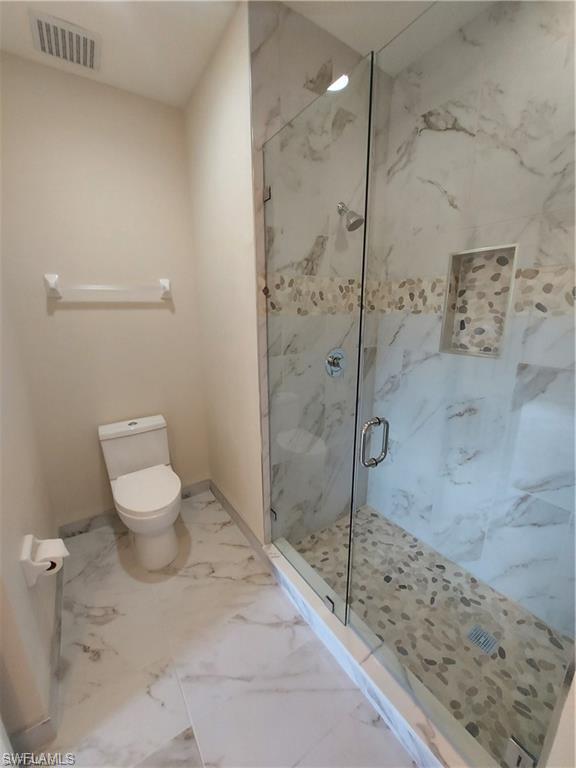 3268 Amanda Lane, Unit 3 Naples, FL 34109 - Photo 10 of 26 a bathroom with a toilet and a shower