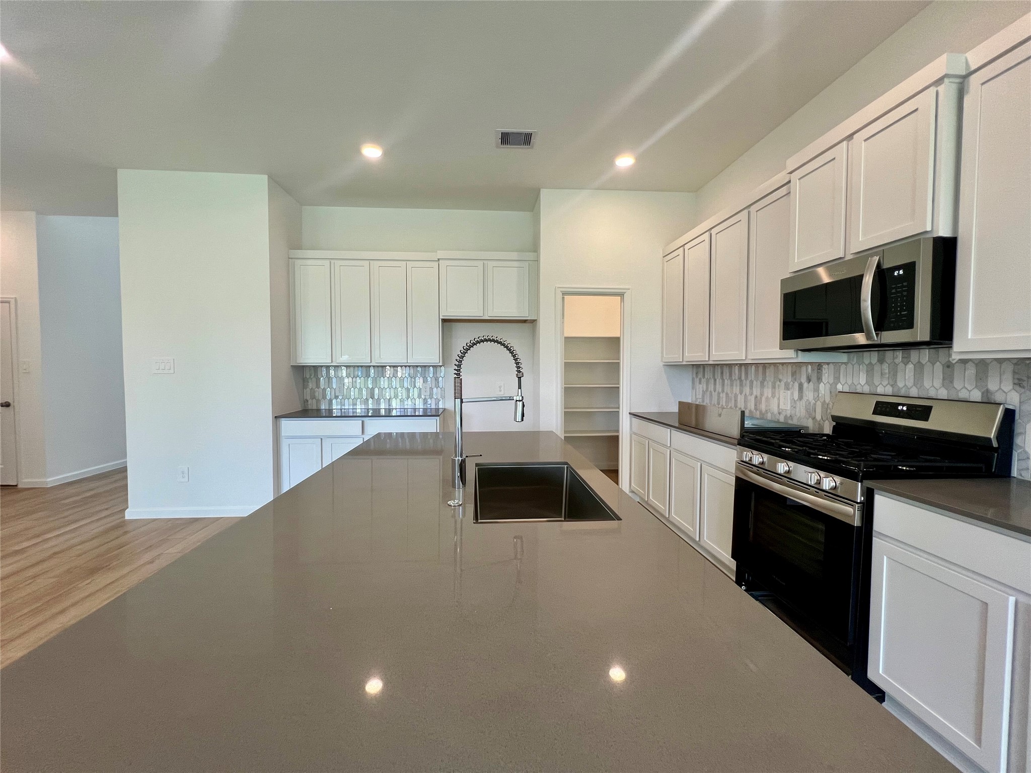 17771 Misty Brk Lane Conroe, TX 77302 - Photo 15 of 48 a kitchen with a sink stove and microwave