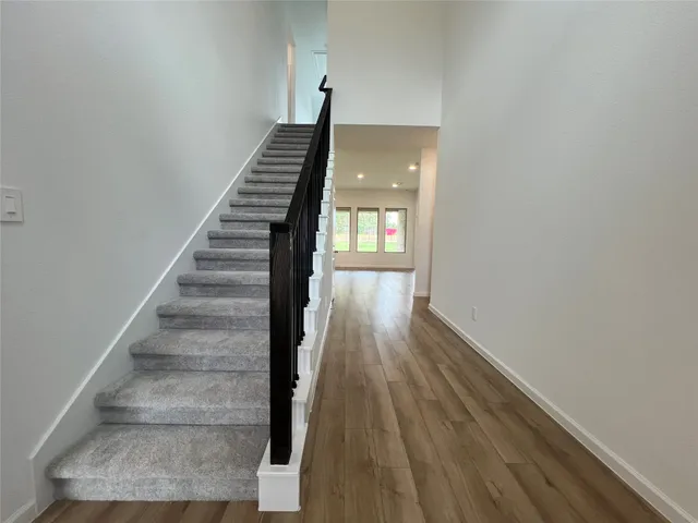 a view of entryway and hall with wooden floor
