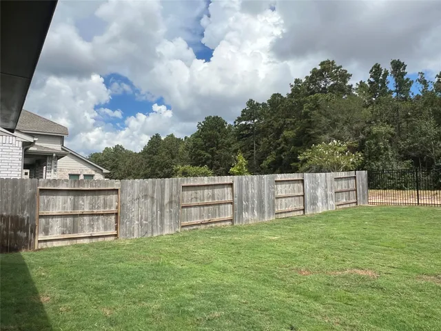 a view of a yard with a large trees