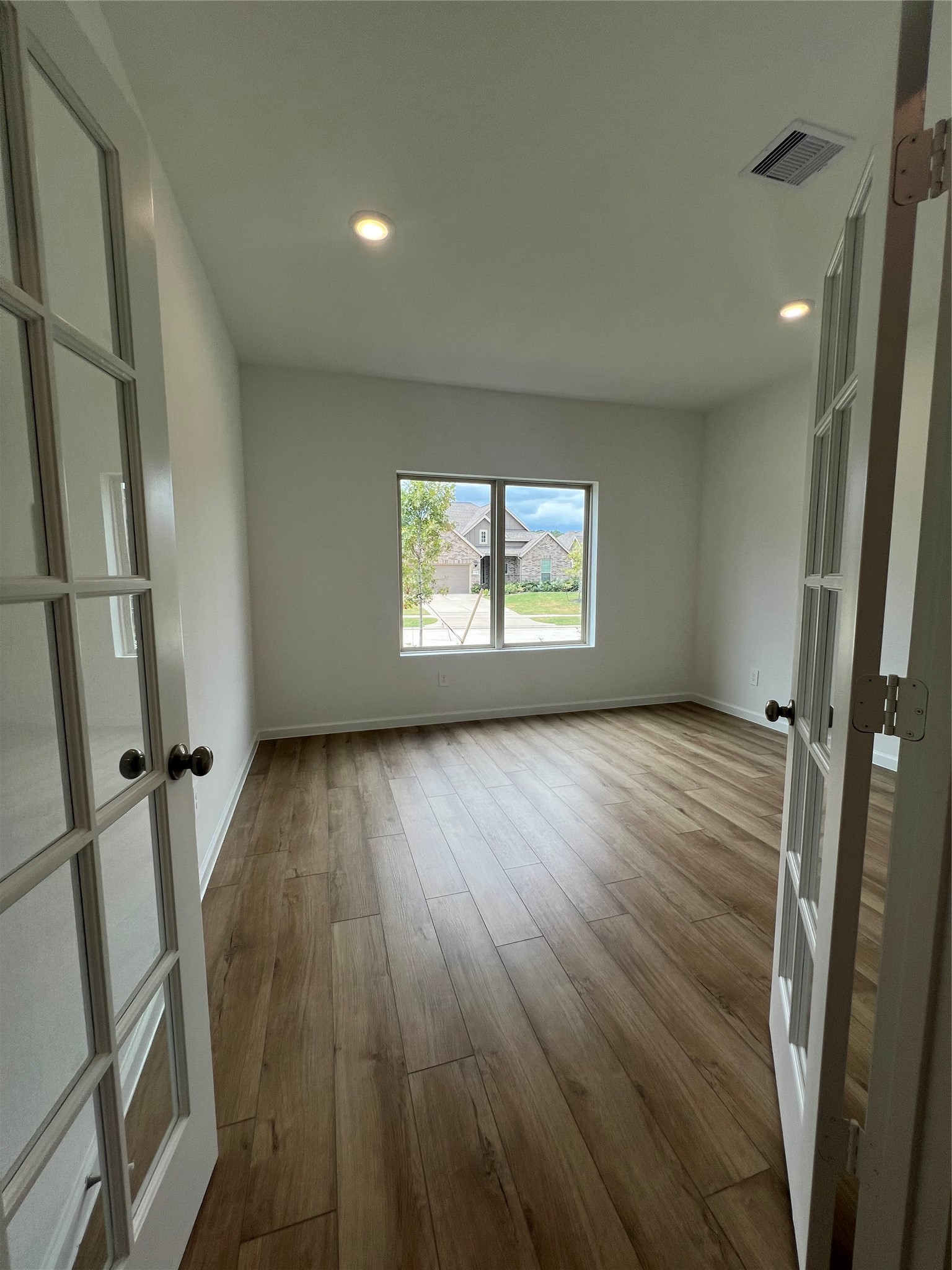 17771 Misty Brk Lane Conroe, TX 77302 - Photo 6 of 48 a view of an empty room with wooden floor and a window