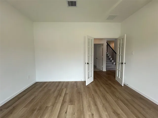 a view of a room with wooden floor