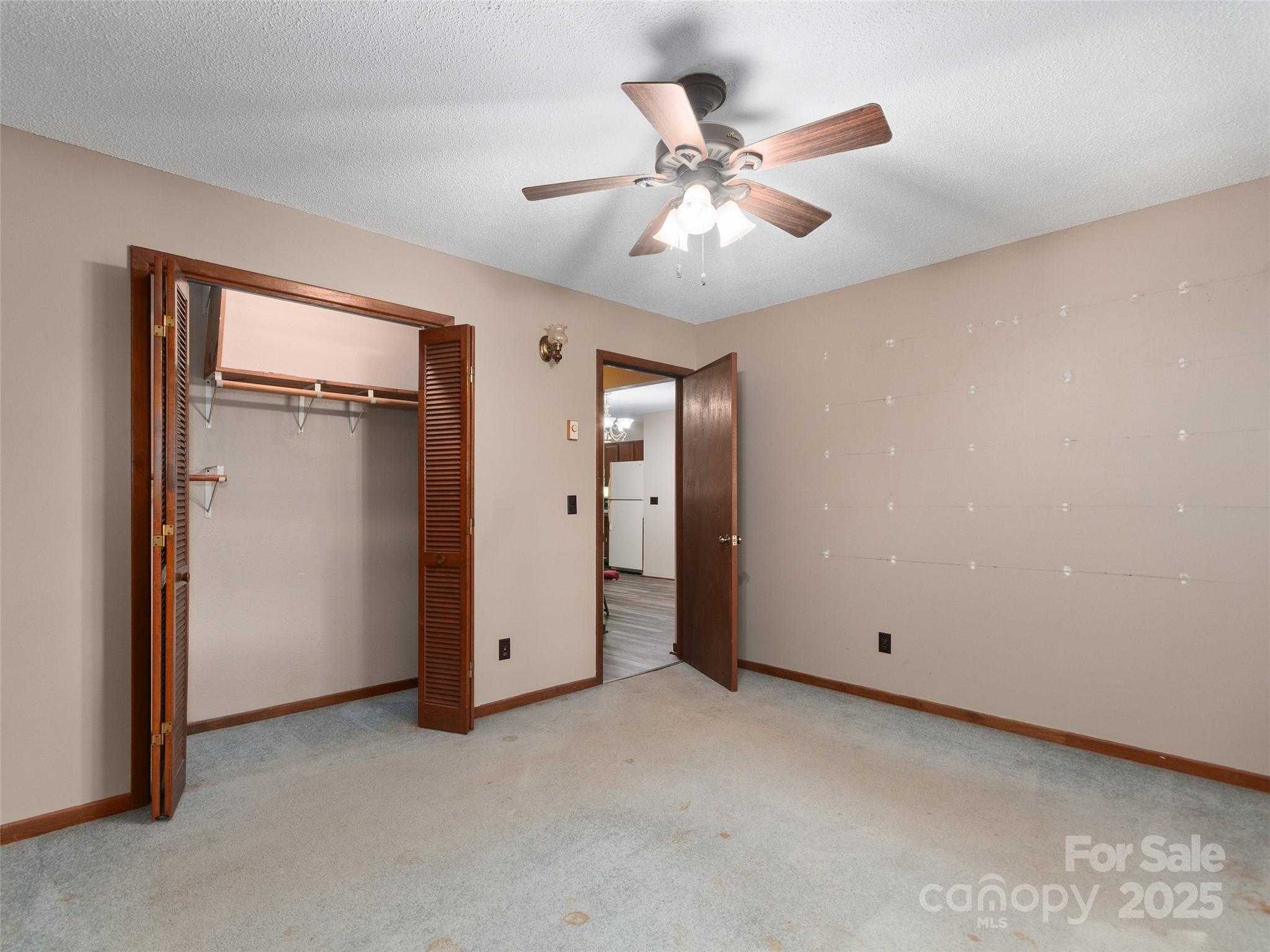 250 Turkey Pen Road Franklin, NC 28734 - Photo 17 of 30 an empty room with closet and fan