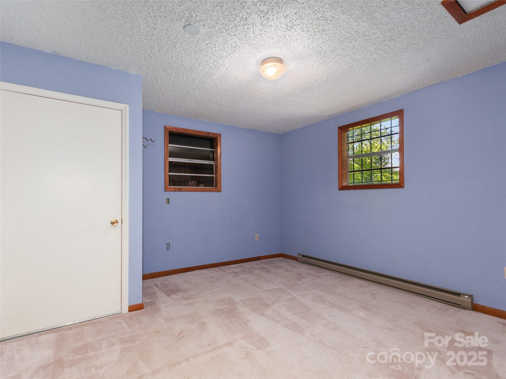 250 Turkey Pen Road Franklin, NC 28734 - Photo 24 of 30 an empty room with windows