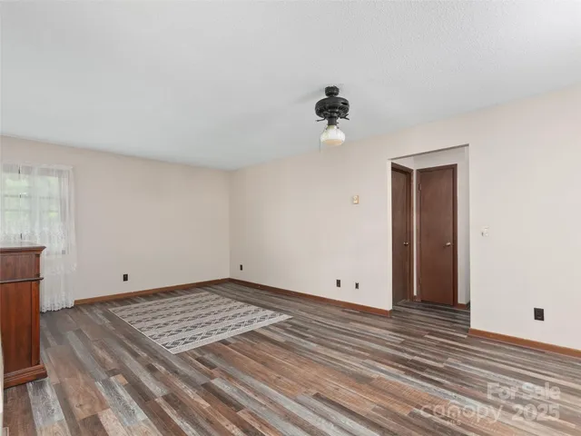 a view of room with hardwood floor and ceiling fan