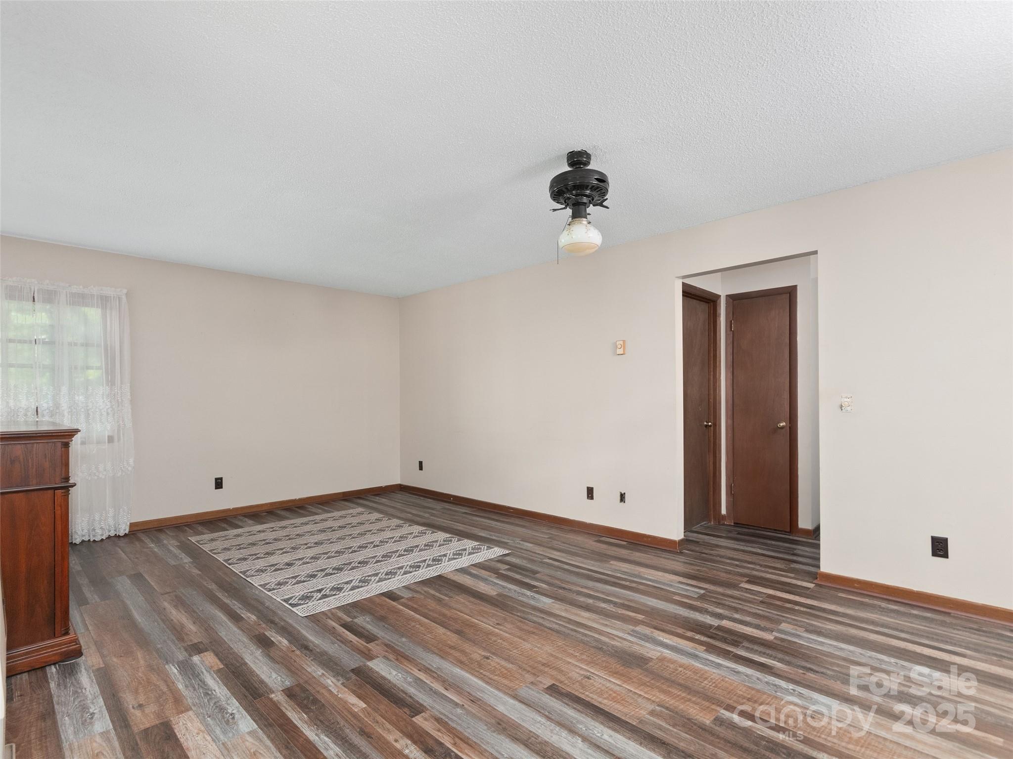 250 Turkey Pen Road Franklin, NC 28734 - Photo 7 of 30 a view of room with hardwood floor and ceiling fan
