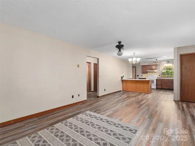 a view of a kitchen with wooden floor and a sink