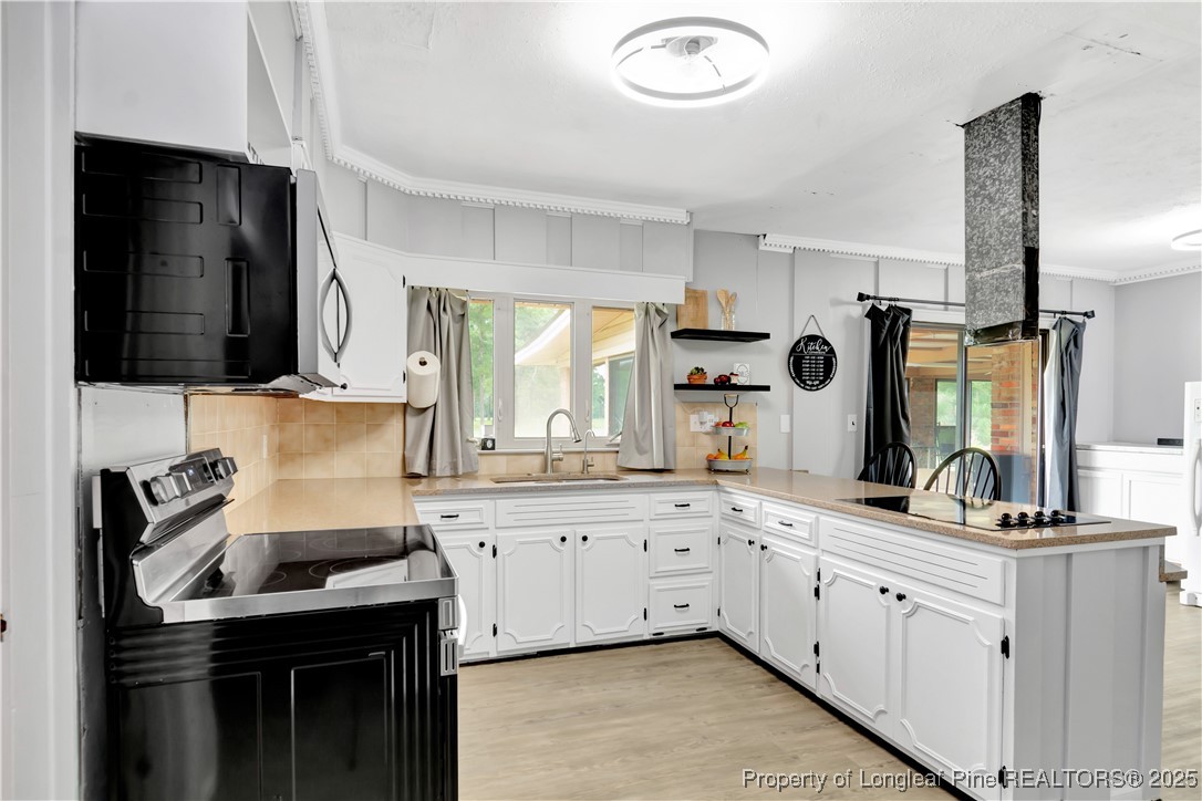 12073 Highway 130 Fairmont, NC 28340 - Photo 13 of 45 a kitchen with a sink stove and cabinets