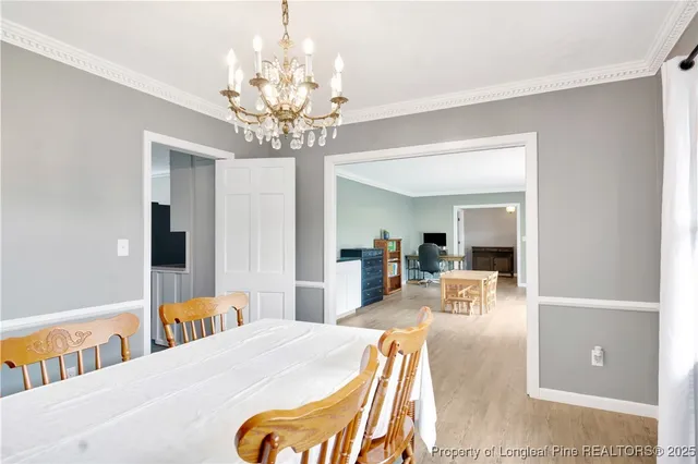 a bedroom with a bed and chandelier