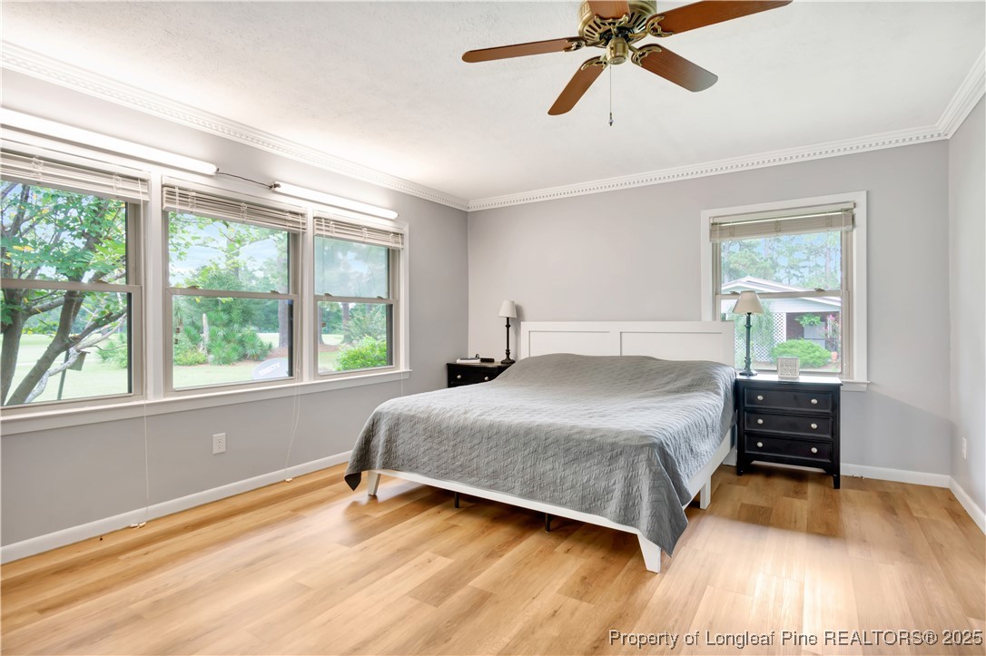 12073 Highway 130 Fairmont, NC 28340 - Photo 23 of 45 a bedroom with a bed and wooden floor