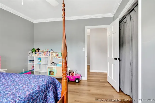 a bedroom with a bed table and a closet