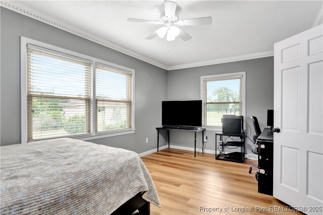 12073 Highway 130 Fairmont, NC 28340 - Photo 32 of 45 a bedroom with a bed and a flat screen tv