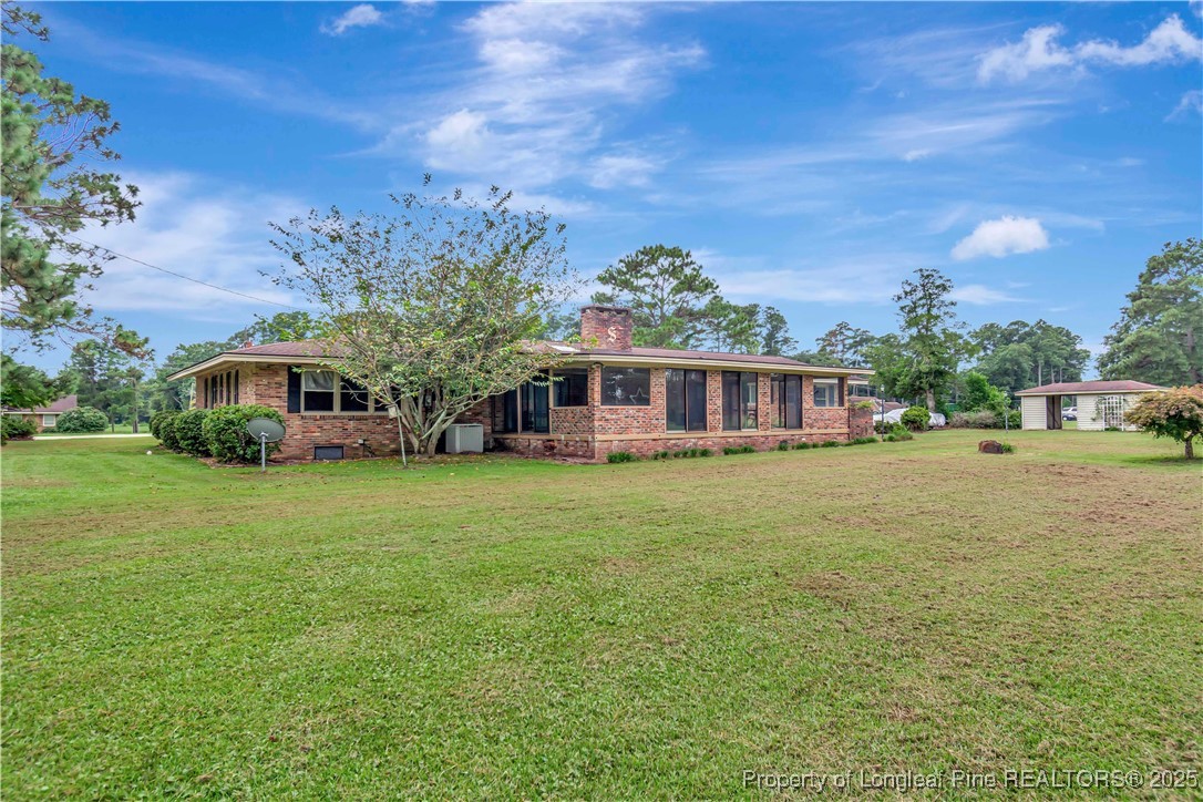 12073 Highway 130 Fairmont, NC 28340 - Photo 42 of 45 a front view of a house with a garden
