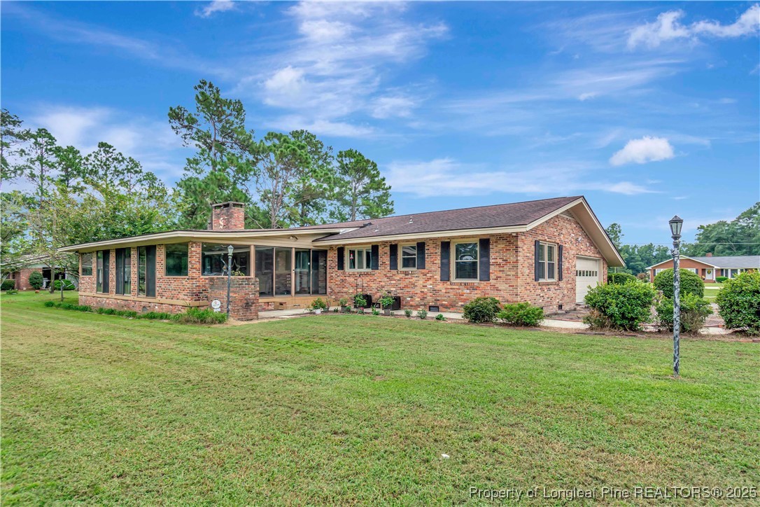 12073 Highway 130 Fairmont, NC 28340 - Photo 43 of 45 a front view of a house with a garden