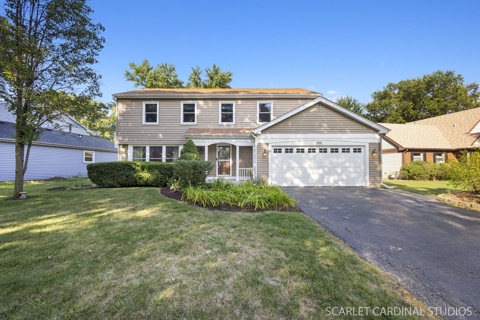 a front view of a house with a garden
