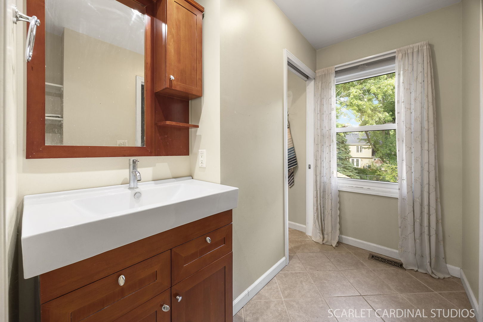 2044 Templar Drive Naperville, IL 60565 - Photo 15 of 28 a bathroom with a sink a mirror and a window