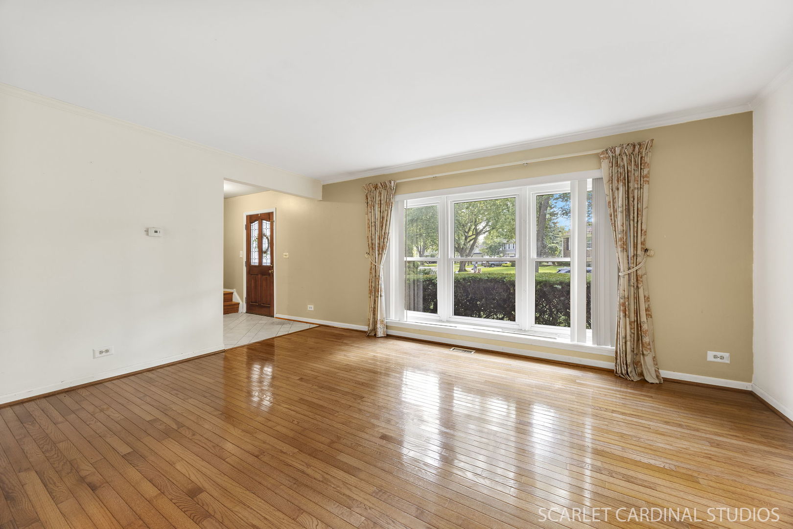 2044 Templar Drive Naperville, IL 60565 - Photo 4 of 28 a view of an empty room with wooden floor and a window