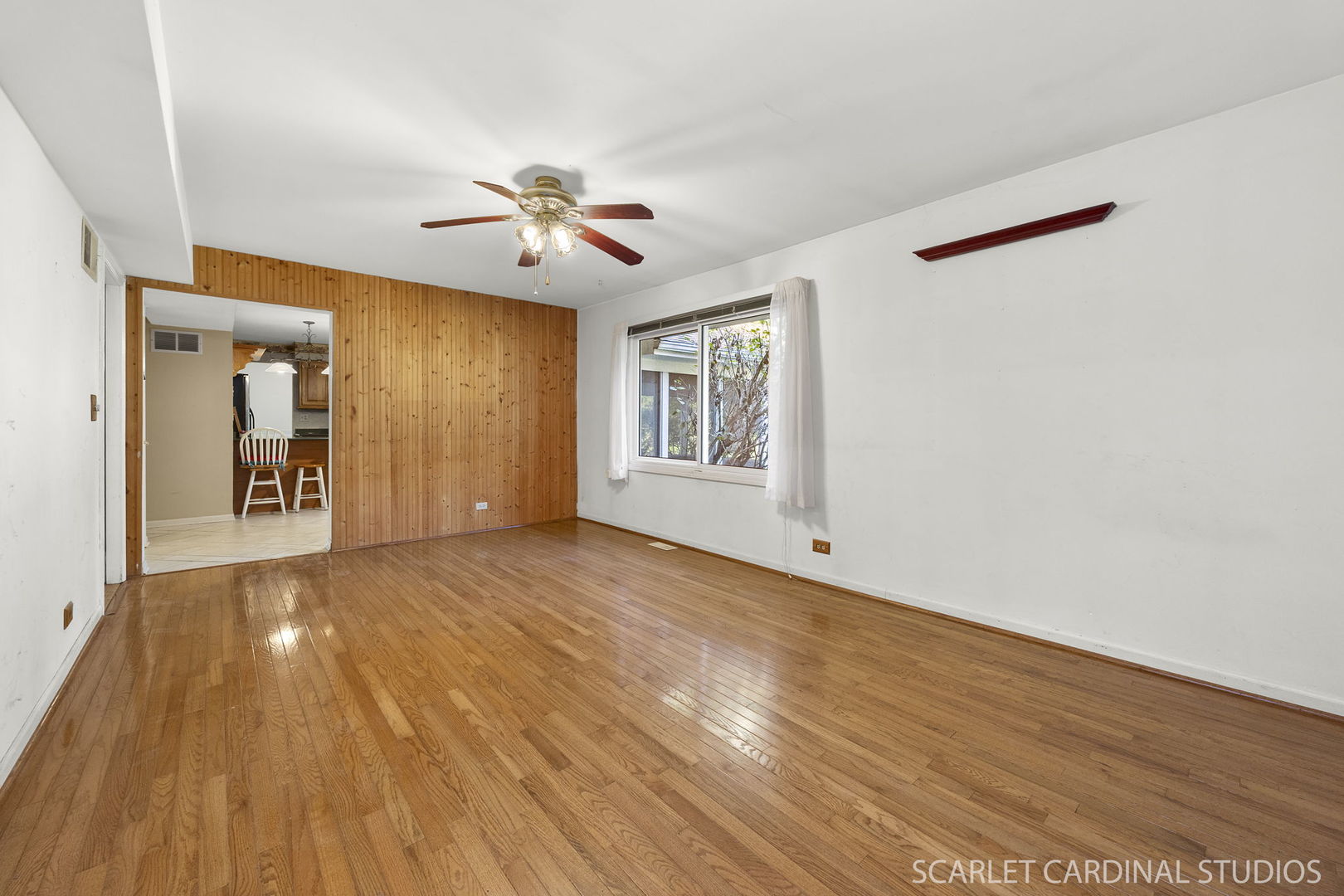 2044 Templar Drive Naperville, IL 60565 - Photo 10 of 28 a view of a livingroom with wooden floor and a ceiling fan