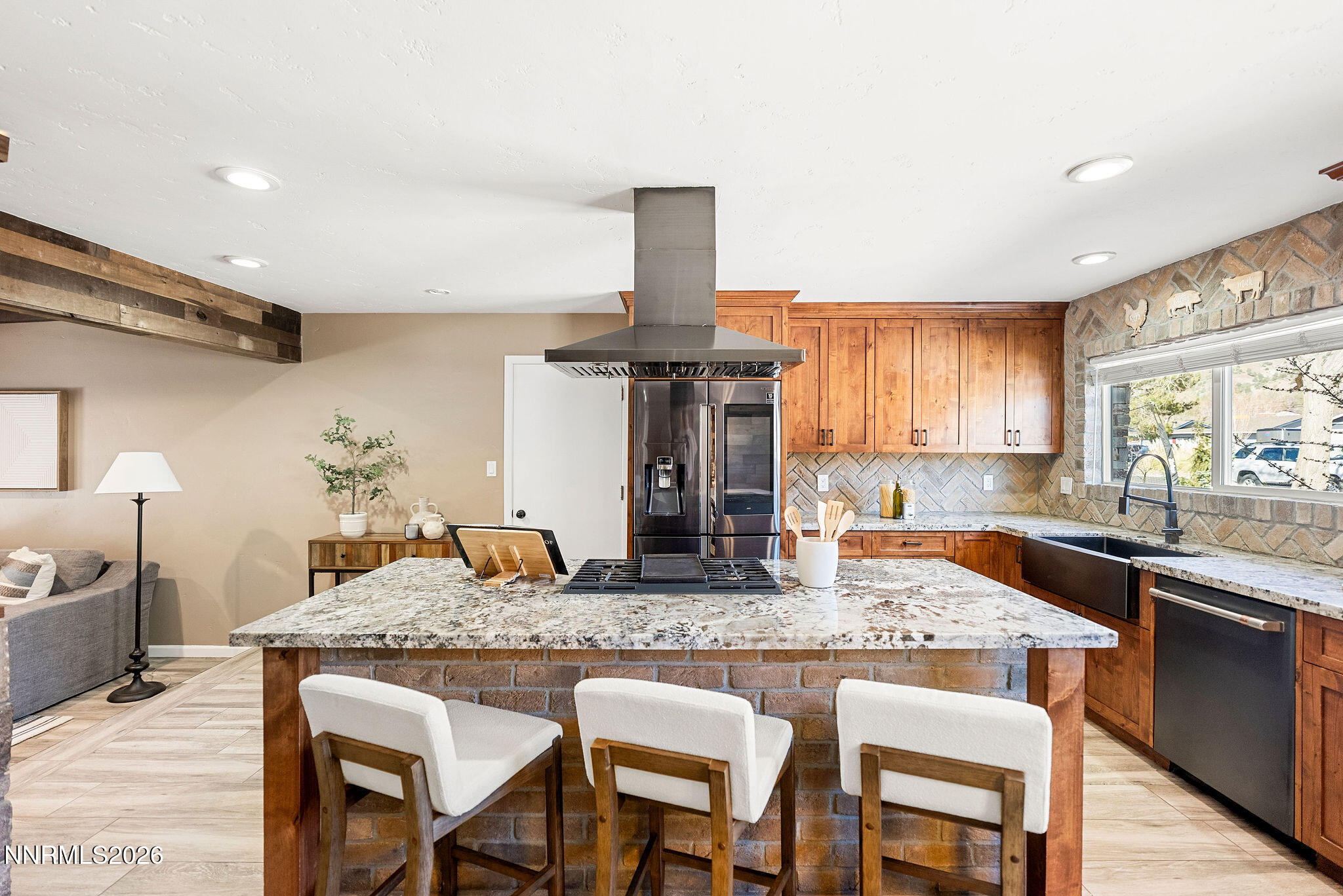 14675 Chamy Drive Reno, NV 89521 - Photo 3 of 86 a kitchen with granite countertop kitchen island wooden cabinets dining table and stainless steel appliances
