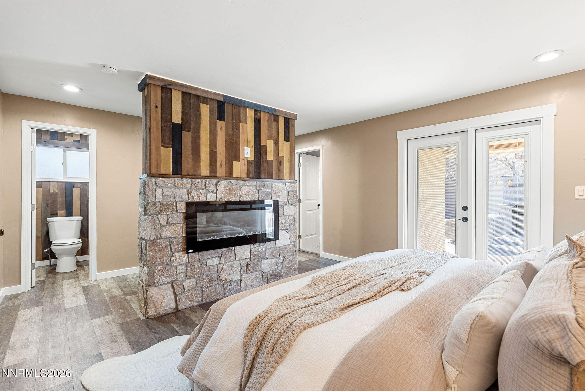 14675 Chamy Drive Reno, NV 89521 - Photo 65 of 86 a bedroom with a bed a fireplace and a large window