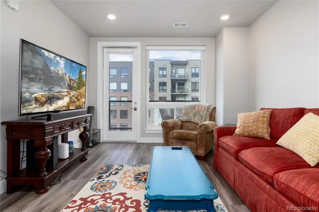 a spacious bathroom with a double vanity sink a mirror and a toilet