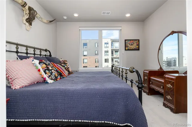 a bedroom with a bed and a lamp