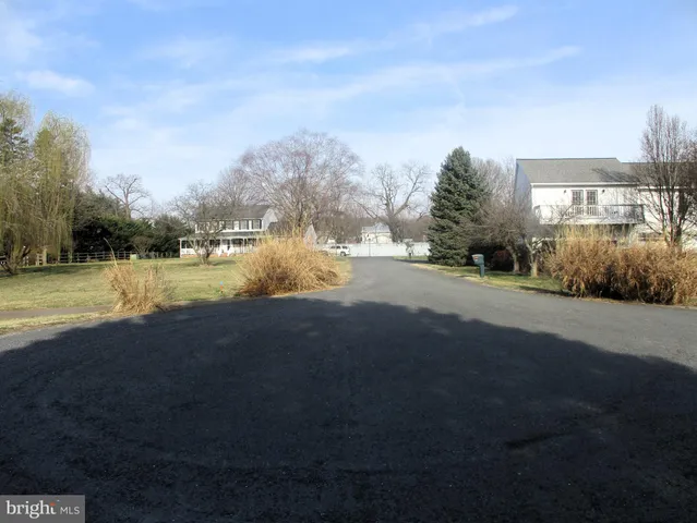 a view of a lake with houses in the background