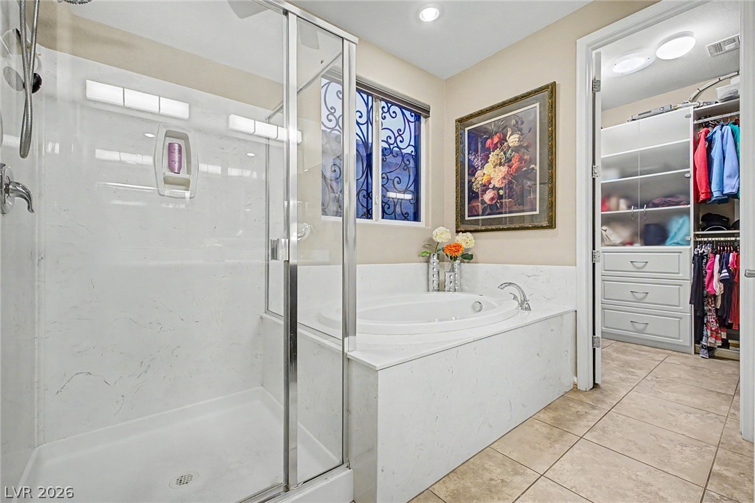 7415 Campbell Ranch Avenue Las Vegas, NV 89179 - Photo 35 of 52 Indulge in a tranquil bathing experience with a luxurious soaking tub and a dedicated walk-in closet for effortless organization.