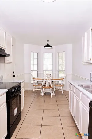 a kitchen with a stove a sink and a refrigerator
