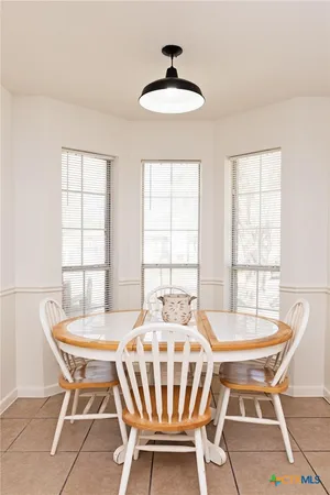 a dining room with furniture and window