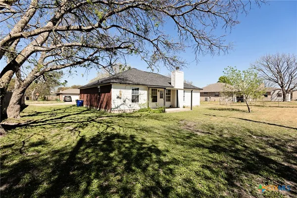 a large house with a large tree in front of it