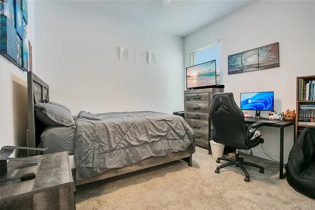 a bedroom with a workspace