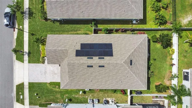 a aerial view of a house with a yard and sitting space