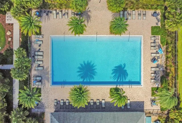 an aerial view of ocean and residential houses with outdoor space