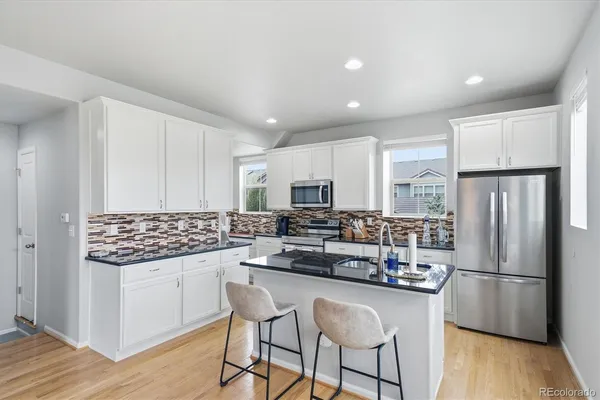 a kitchen with stainless steel appliances a refrigerator stove microwave and cabinets