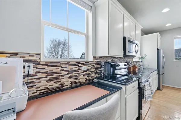 a kitchen with stainless steel appliances a stove and a refrigerator