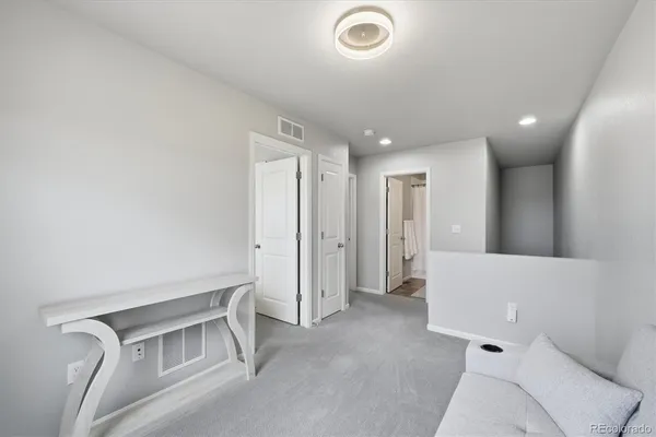 a large bed sitting in a bedroom next to a window