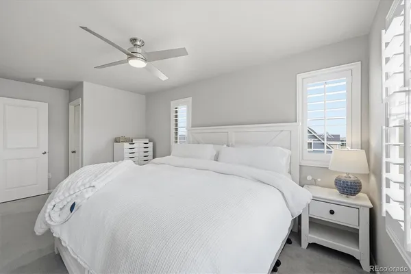 a bedroom with a bed and a mirror