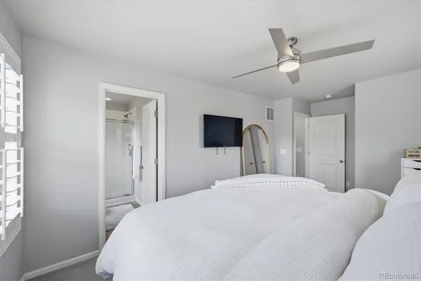 a bathroom with a granite countertop sink toilet a mirror and shower