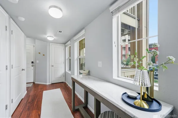 a kitchen with a stove and wooden floor