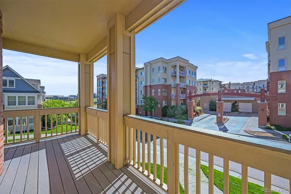 a view of a brick house with a big yard and potted plants
