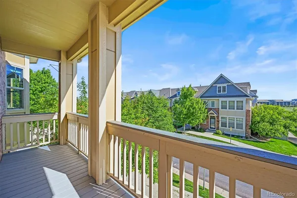 a brick building with a bench on the wooden floor