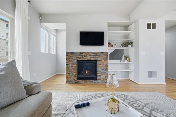 a living room with furniture and a fireplace
