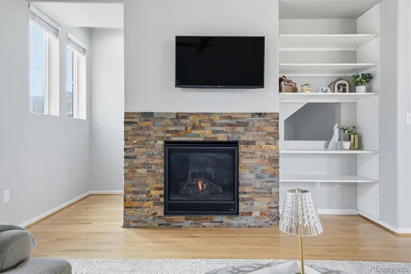 a living room with a fireplace and a flat screen tv