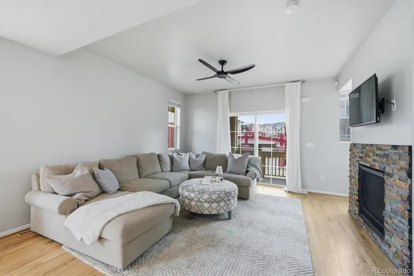 a living room with furniture and a fireplace
